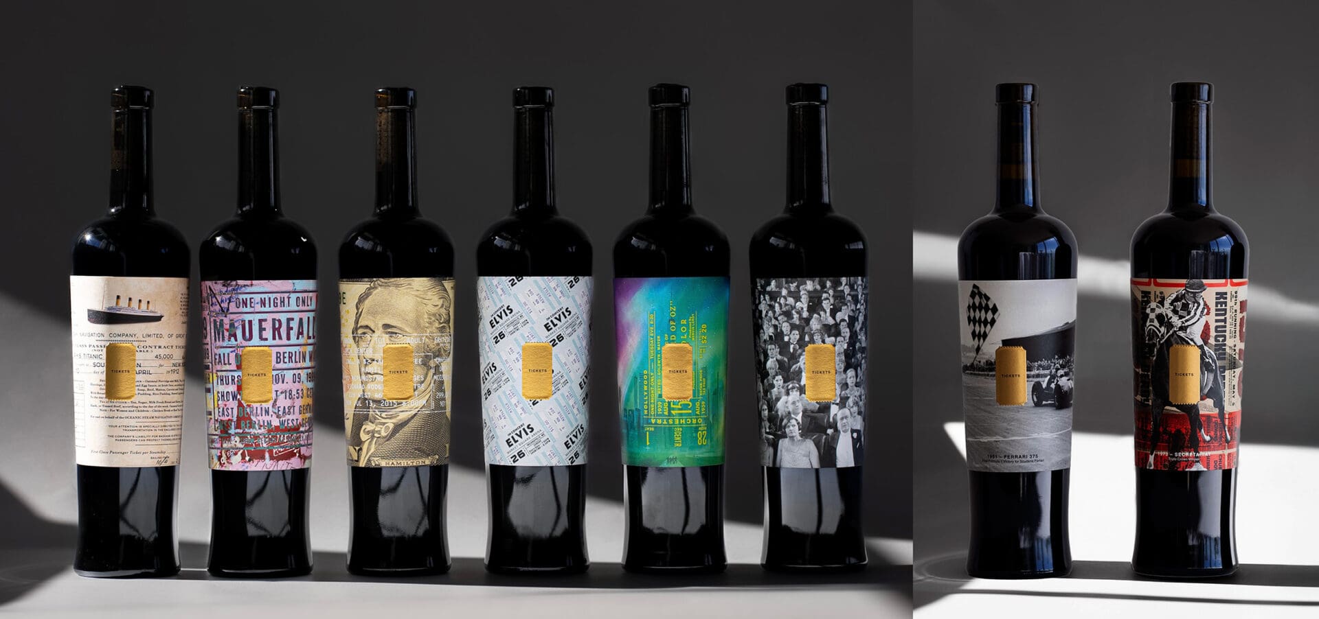 Seven wine bottles with colorful labels displayed.